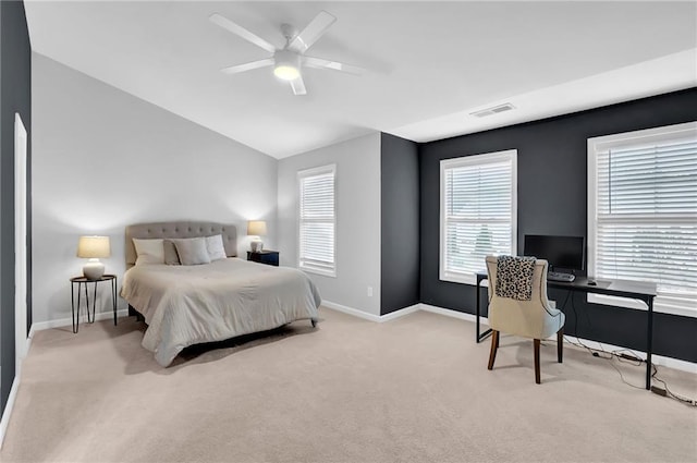 carpeted bedroom featuring visible vents, baseboards, a ceiling fan, and lofted ceiling