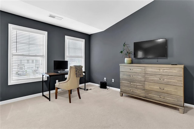 office space with visible vents, baseboards, plenty of natural light, and light carpet