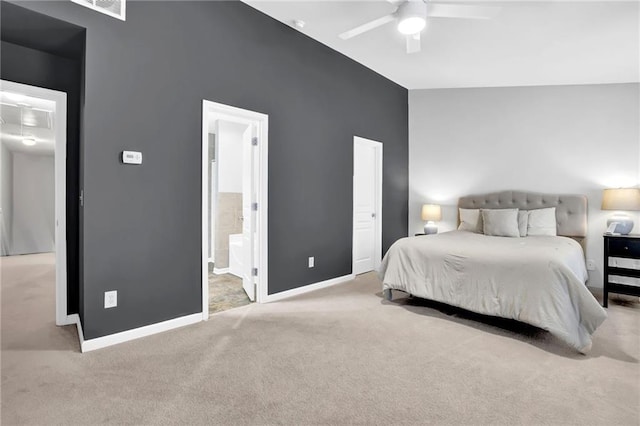 bedroom with baseboards, ceiling fan, carpet, ensuite bath, and lofted ceiling
