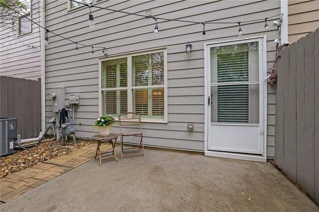 view of patio with central AC and fence