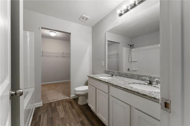 222 Parkland Way, Chatsworth, GA 30705 - bathroom with double vanity, wood finished floors, a walk in closet, and shower / bathtub combination