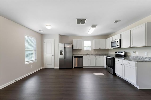 222 Parkland Way, Chatsworth, GA 30705 - kitchen with stainless steel appliances, dark wood-style flooring, white cabinetry, and light stone countertops
