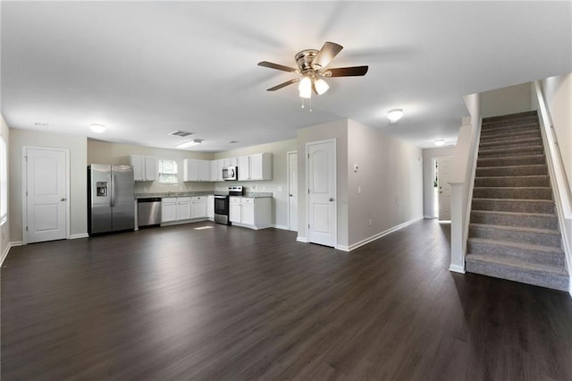 222 Parkland Way, Chatsworth, GA 30705 - unfurnished living room with dark wood-type flooring, ceiling fan, and stairway