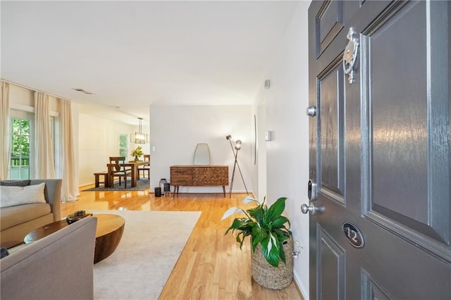 foyer featuring baseboards and wood finished floors