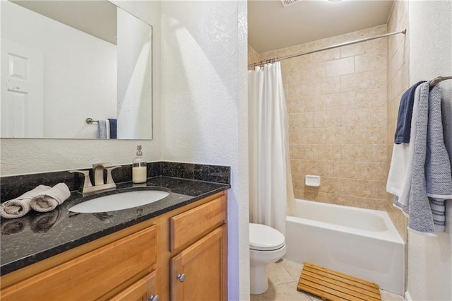 full bath featuring a textured wall, toilet, shower / tub combo, vanity, and tile patterned floors