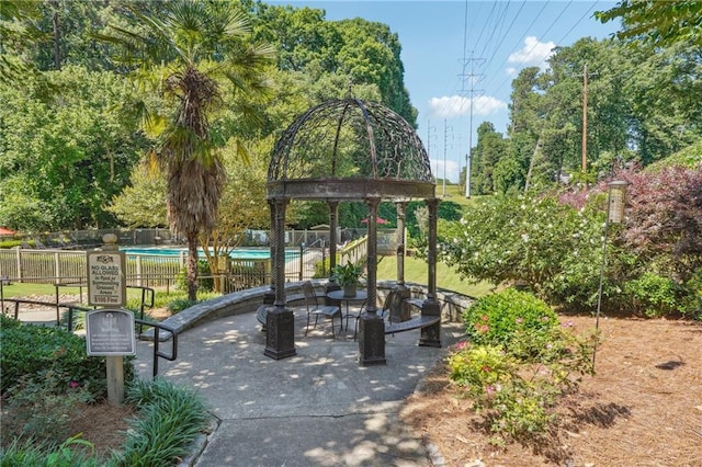 view of community with fence and a pool