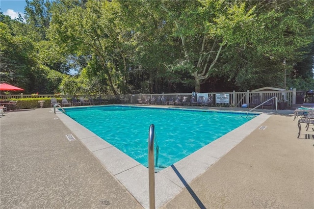 pool featuring fence and a patio