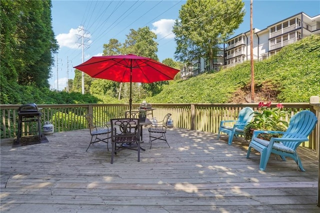 deck with outdoor dining area and area for grilling