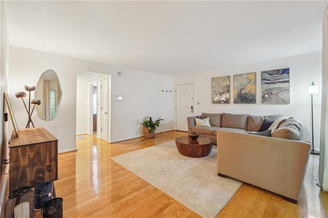 living area featuring light wood finished floors and baseboards