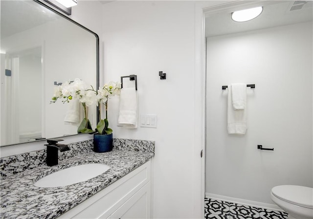 bathroom with tile patterned floors, vanity, and toilet