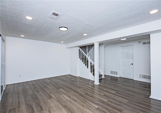 basement with dark hardwood / wood-style floors and a textured ceiling