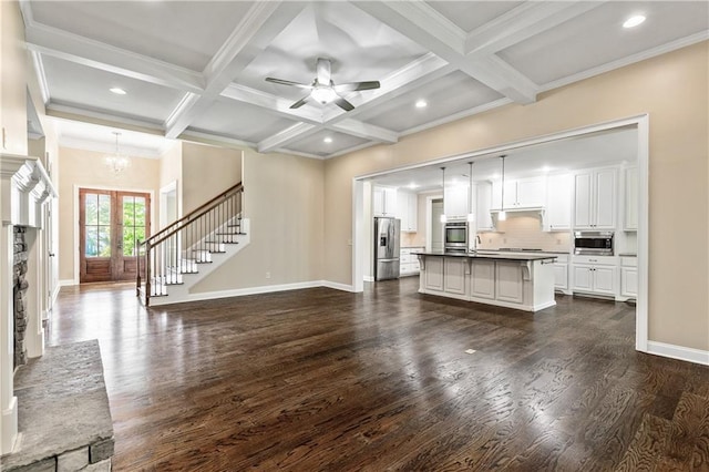 214 Westwind Dr, Newnan, GA 30263 - unfurnished living room with dark wood-type flooring, beam ceiling, a chandelier, coffered ceiling, and a sink