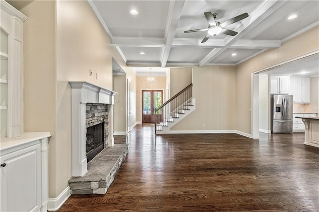 214 Westwind Dr, Newnan, GA 30263 - unfurnished living room with dark wood-style flooring, a ceiling fan, beam ceiling, a stone fireplace, and recessed lighting