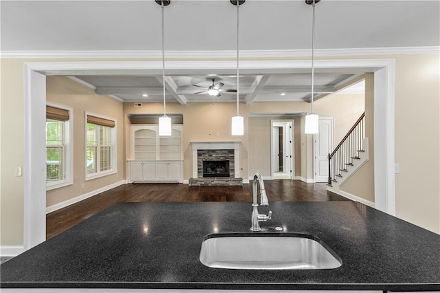 214 Westwind Dr, Newnan, GA 30263 - kitchen featuring a sink, dark wood-type flooring, ceiling fan, open floor plan, and a stone fireplace