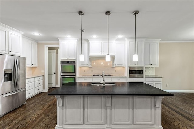 214 Westwind Dr, Newnan, GA 30263 - kitchen with appliances with stainless steel finishes, a sink, tasteful backsplash, dark wood finished floors, and white cabinetry