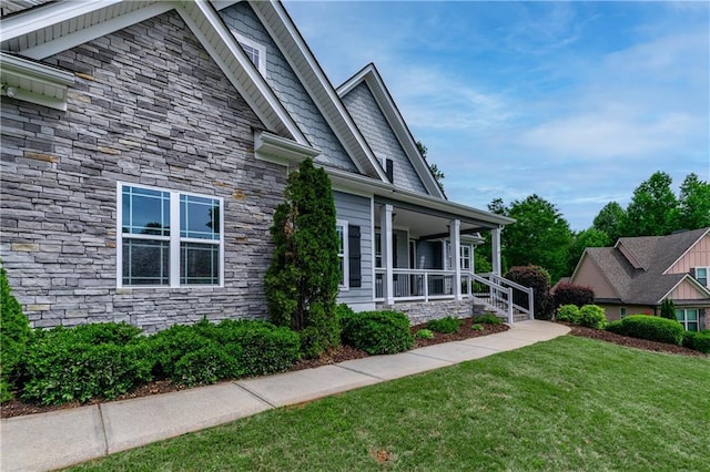 214 Westwind Dr, Newnan, GA 30263 - view of home's exterior featuring stone siding, a porch, and a lawn