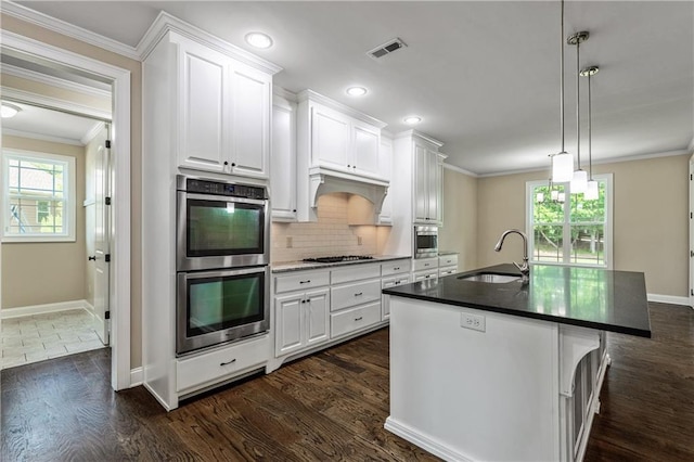 214 Westwind Dr, Newnan, GA 30263 - kitchen with a sink, stainless steel appliances, crown molding, dark wood-style floors, and white cabinetry