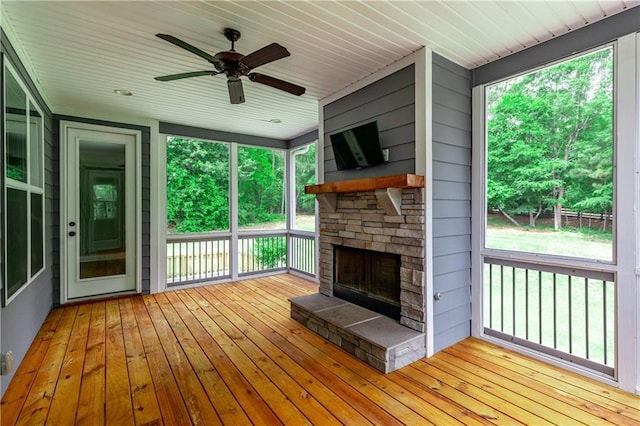214 Westwind Dr, Newnan, GA 30263 - unfurnished sunroom with a fireplace, ceiling fan, and plenty of natural light