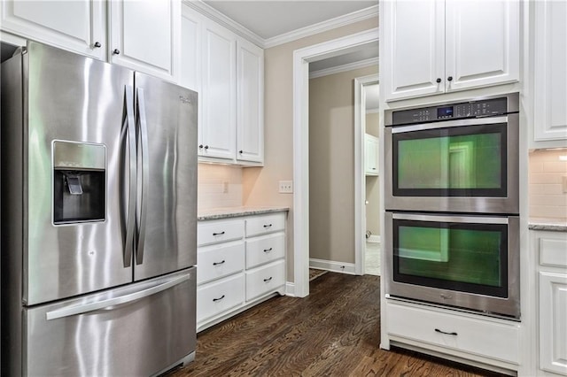 214 Westwind Dr, Newnan, GA 30263 - kitchen with stainless steel appliances, crown molding, dark wood-type flooring, white cabinetry, and backsplash