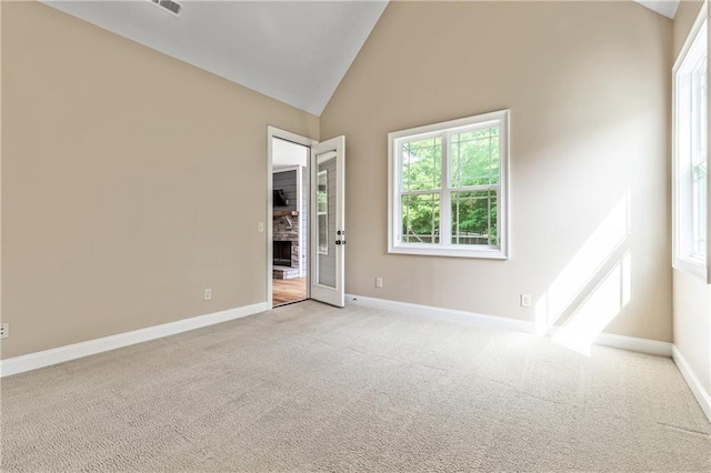 214 Westwind Dr, Newnan, GA 30263 - spare room featuring baseboards, light colored carpet, and high vaulted ceiling