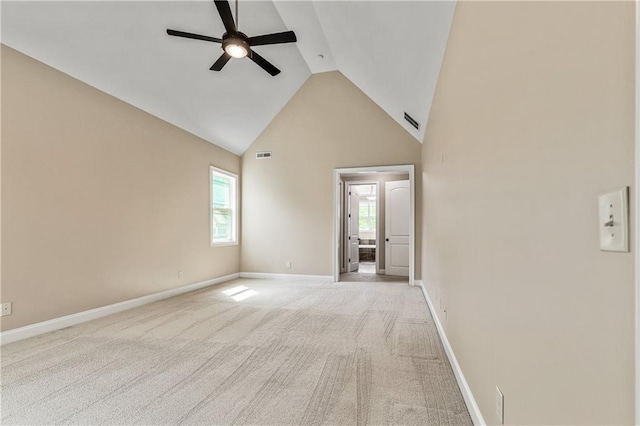 214 Westwind Dr, Newnan, GA 30263 - unfurnished living room with ceiling fan, high vaulted ceiling, light carpet, and baseboards