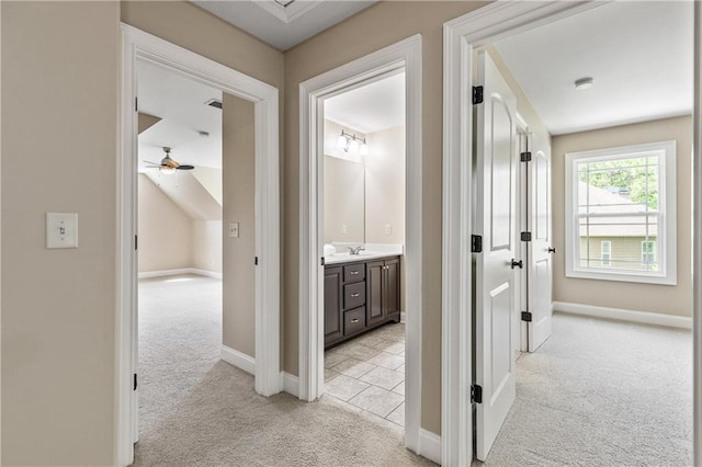 214 Westwind Dr, Newnan, GA 30263 - hall with light carpet, a sink, and baseboards