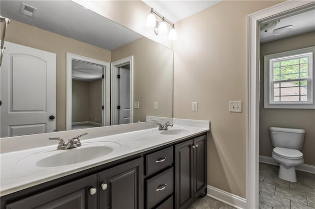 214 Westwind Dr, Newnan, GA 30263 - full bath featuring double vanity, baseboards, and toilet