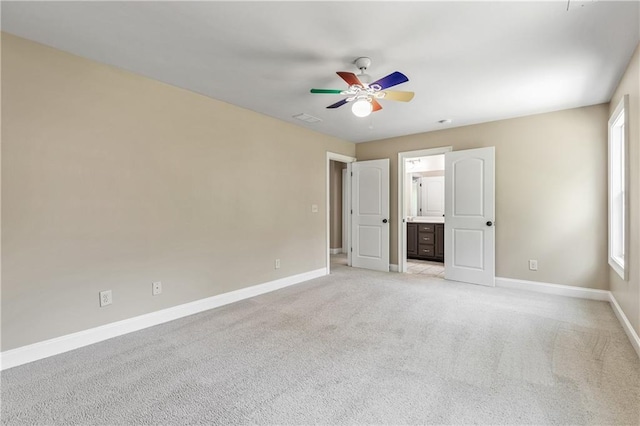 214 Westwind Dr, Newnan, GA 30263 - unfurnished bedroom featuring baseboards, light carpet, multiple windows, and connected bathroom