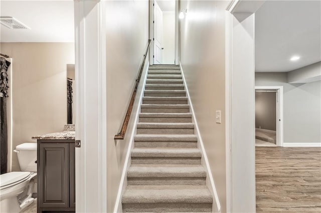 214 Westwind Dr, Newnan, GA 30263 - stairway featuring wood finished floors, baseboards, and recessed lighting
