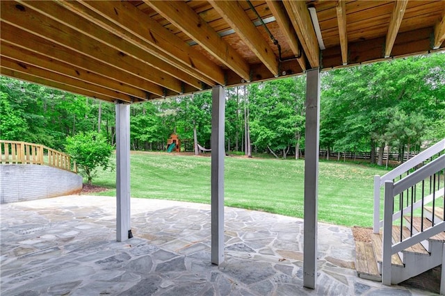 214 Westwind Dr, Newnan, GA 30263 - view of patio featuring a playground, stairway, and view of wooded area
