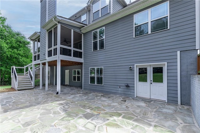 214 Westwind Dr, Newnan, GA 30263 - rear view of house featuring a sunroom, a ceiling fan, stairway, a chimney, and a patio