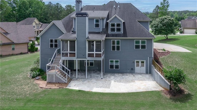 214 Westwind Dr, Newnan, GA 30263 - back of house with a patio, a chimney, a lawn, and a sunroom