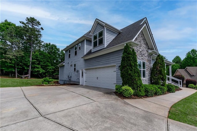 214 Westwind Dr, Newnan, GA 30263 - view of property exterior featuring stone siding, concrete driveway, and a yard