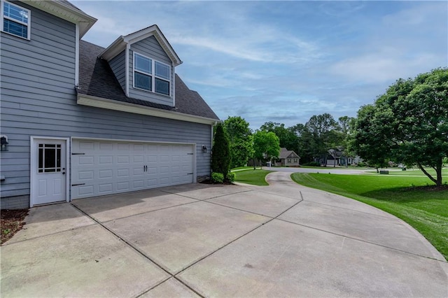 214 Westwind Dr, Newnan, GA 30263 - view of home's exterior featuring a lawn, driveway, a garage, and roof with shingles