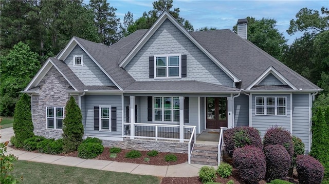 214 Westwind Dr, Newnan, GA 30263 - craftsman-style home with a porch, a chimney, and a shingled roof