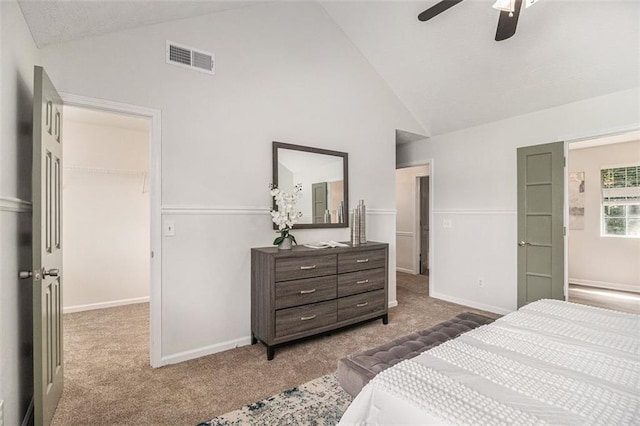 3440 Oaktree Way, Stonecrest, GA 30038 - carpeted bedroom with vaulted ceiling, a walk in closet, and a ceiling fan