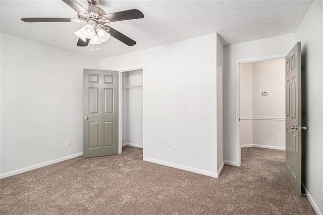 3440 Oaktree Way, Stonecrest, GA 30038 - unfurnished bedroom featuring carpet flooring, a closet, a textured ceiling, and a ceiling fan