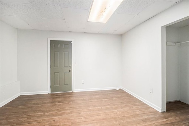 3440 Oaktree Way, Stonecrest, GA 30038 - unfurnished bedroom with a drop ceiling, light wood-style floors, a spacious closet, and a closet