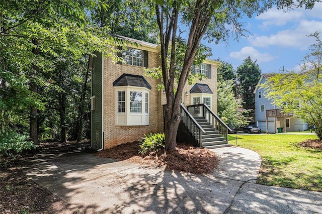 3440 Oaktree Way, Stonecrest, GA 30038 - view of front facade featuring brick siding, a front lawn, stairs, and driveway