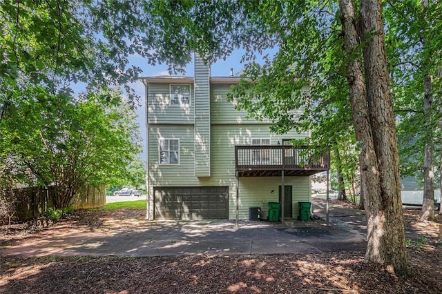 3440 Oaktree Way, Stonecrest, GA 30038 - rear view of property with a deck, a chimney, driveway, and a garage