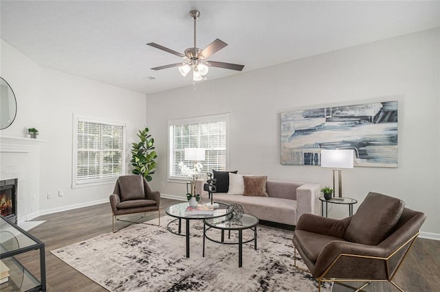3440 Oaktree Way, Stonecrest, GA 30038 - living room featuring wood finished floors, a ceiling fan, and a tiled fireplace