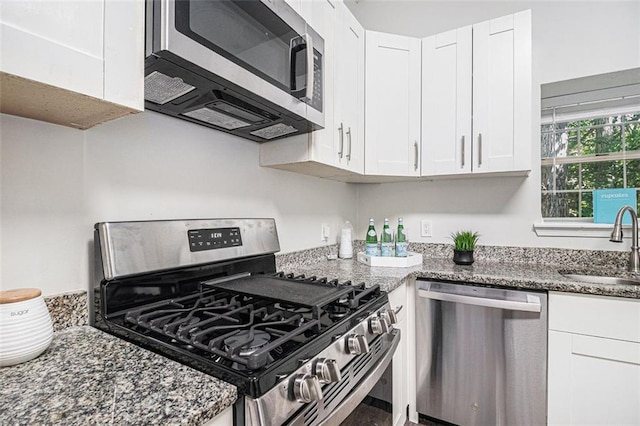 3440 Oaktree Way, Stonecrest, GA 30038 - kitchen with appliances with stainless steel finishes, white cabinets, and dark stone countertops