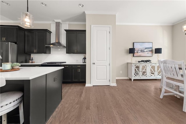 20057 Windalier Way, Roswell, GA 30076 - kitchen with wall chimney range hood, freestanding refrigerator, wood finished floors, a kitchen bar, and light countertops