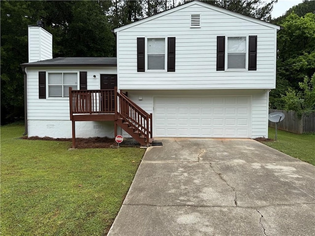 tri-level home with a garage, a chimney, driveway, and a front lawn