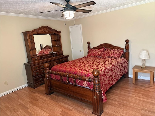 bedroom with light wood-style floors, a textured ceiling, baseboards, and ceiling fan