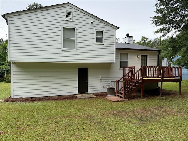 back of house with central AC, a deck, a chimney, stairs, and a yard