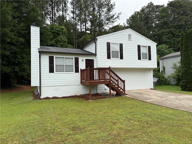 split level home featuring a garage, a front yard, a chimney, and concrete driveway