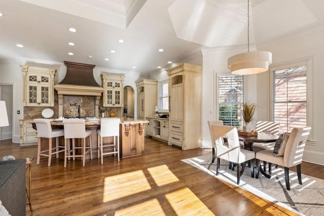 2250 Blackheath Trce, Alpharetta, GA 30005 - kitchen featuring cream cabinetry, custom exhaust hood, ornamental molding, tasteful backsplash, and a center island with sink