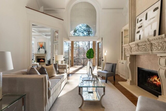 2250 Blackheath Trce, Alpharetta, GA 30005 - living room with a fireplace, wood finished floors, a high ceiling, beamed ceiling, and ornamental molding
