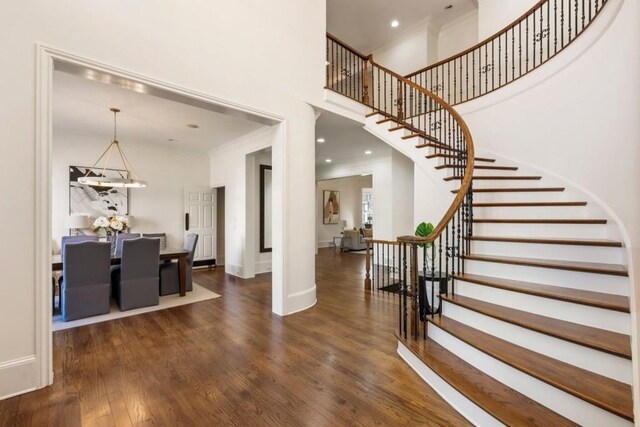 2250 Blackheath Trce, Alpharetta, GA 30005 - entryway with a chandelier, a towering ceiling, ornamental molding, stairs, and wood finished floors